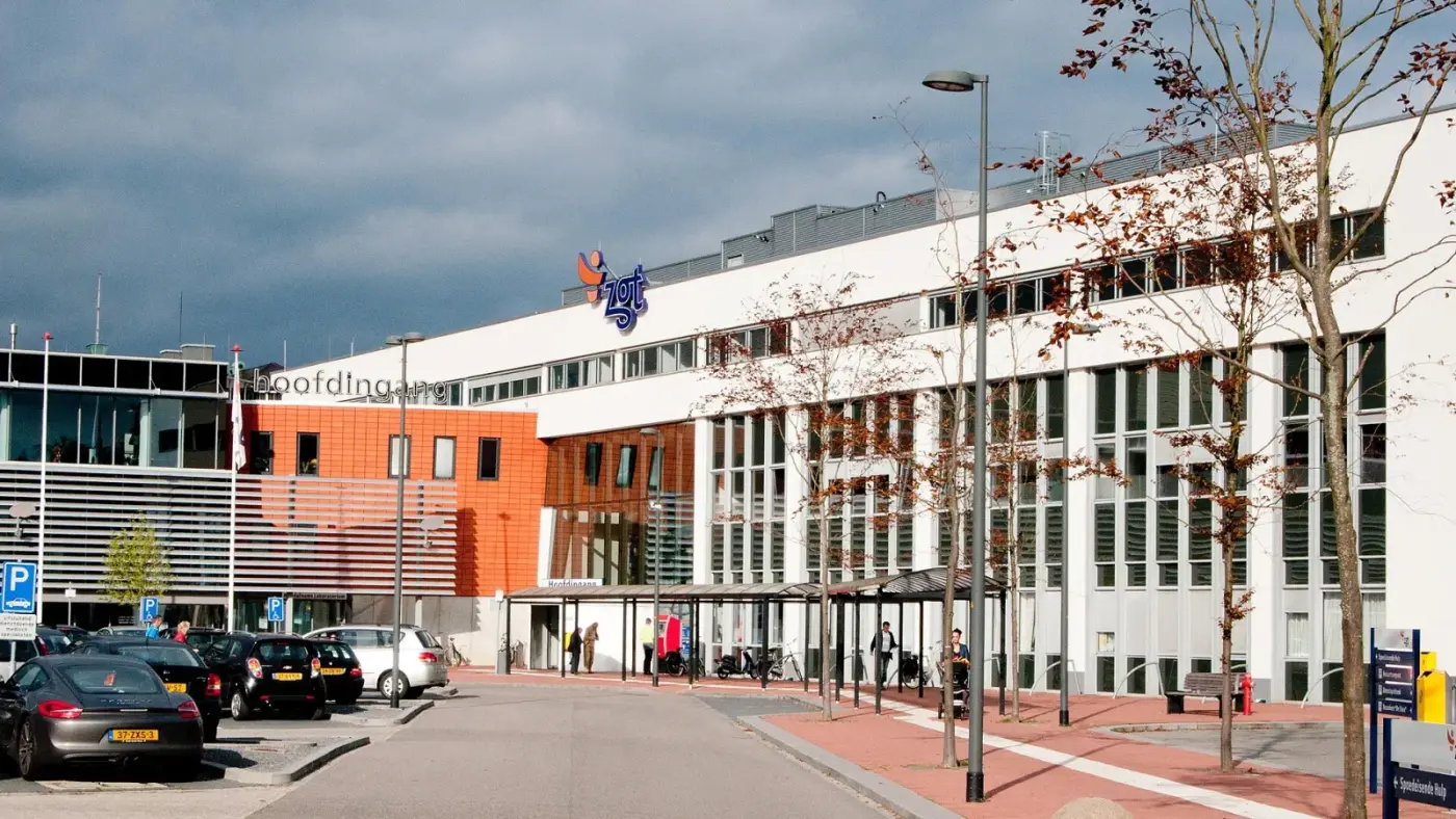 Voorzijde van ZGT Hengelo met parkeerplaatsen en de overdekte looproute naar de hoofdingang